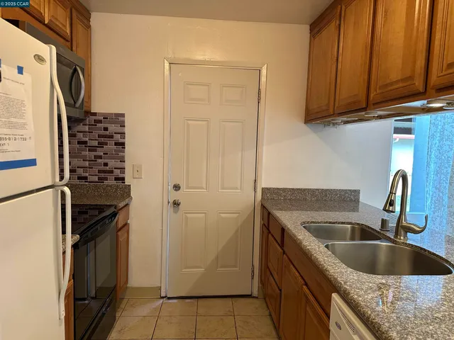 a kitchen with a refrigerator and a sink