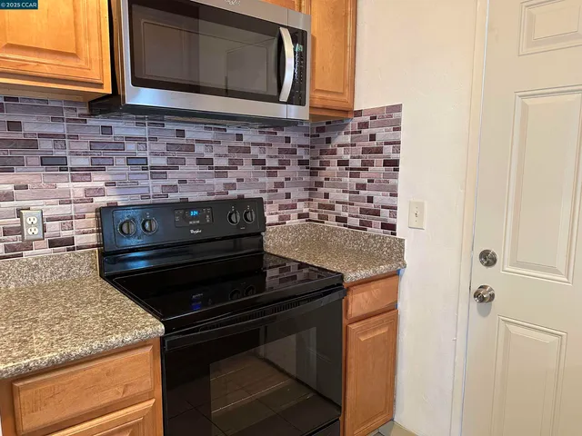 a stove top oven sitting inside of a kitchen
