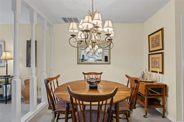 a view of a dining room with furniture and chandelier