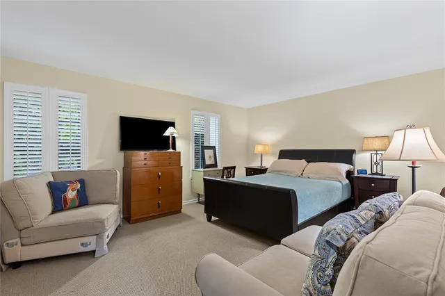 a bedroom with a bed and a couch