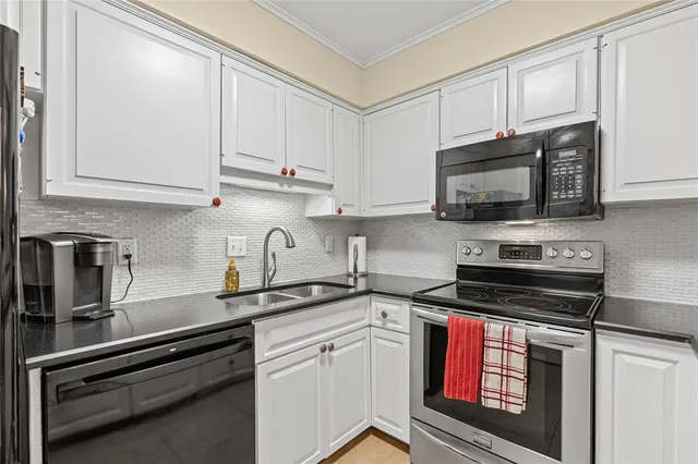 a kitchen with cabinets stainless steel appliances and a sink