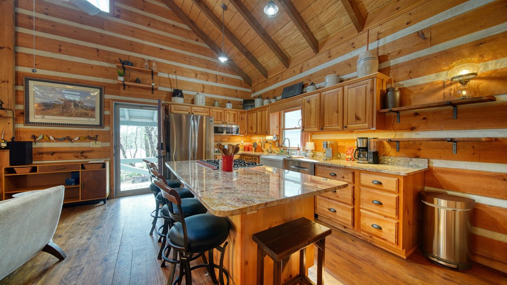 492 Chinkapin Drive Blue Ridge, GA 30513 - Photo 24 of 45 a kitchen with stainless steel appliances granite countertop a stove top oven a sink dishwasher and cabinets with wooden floor