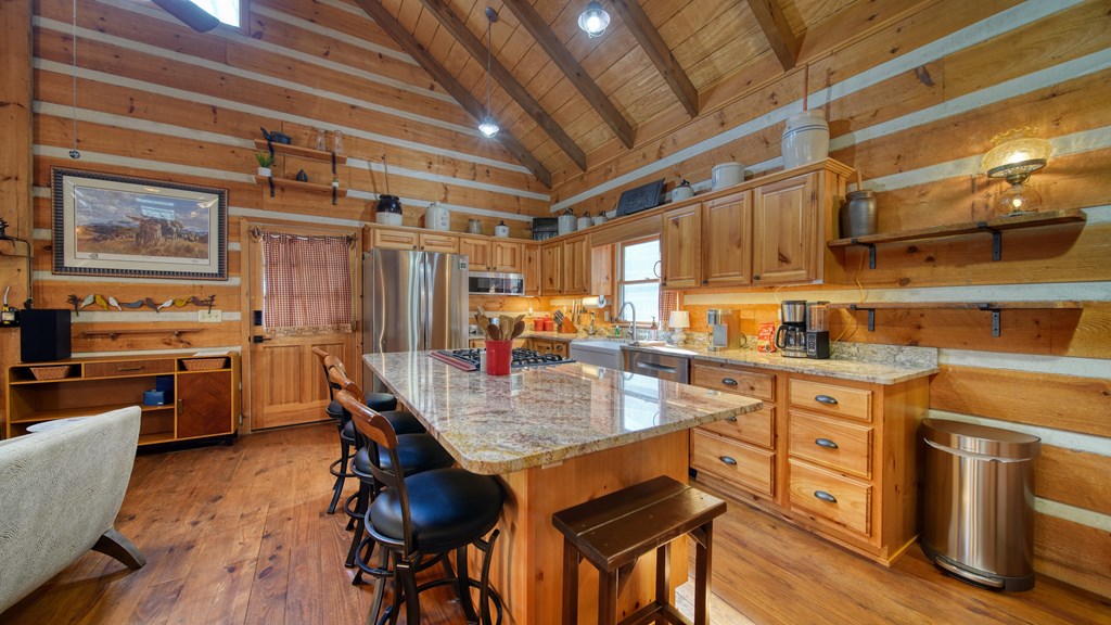492 Chinkapin Drive Blue Ridge, GA 30513 - Photo 25 of 45 a open kitchen with stainless steel appliances granite countertop a stove a sink dishwasher and cabinets with wooden floor