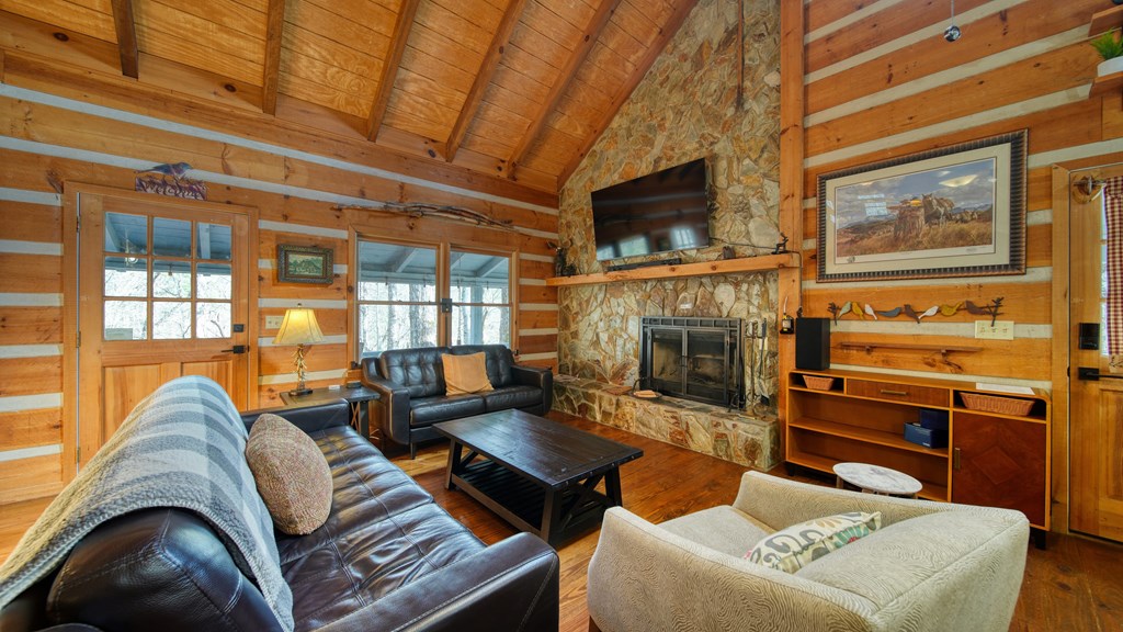 492 Chinkapin Drive Blue Ridge, GA 30513 - Photo 30 of 45 a living room with furniture a flat screen tv and a fireplace