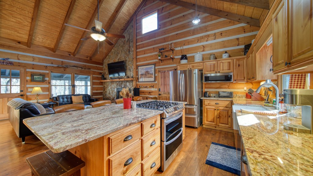 492 Chinkapin Drive Blue Ridge, GA 30513 - Photo 31 of 45 a kitchen with stainless steel appliances granite countertop a sink and wooden cabinets