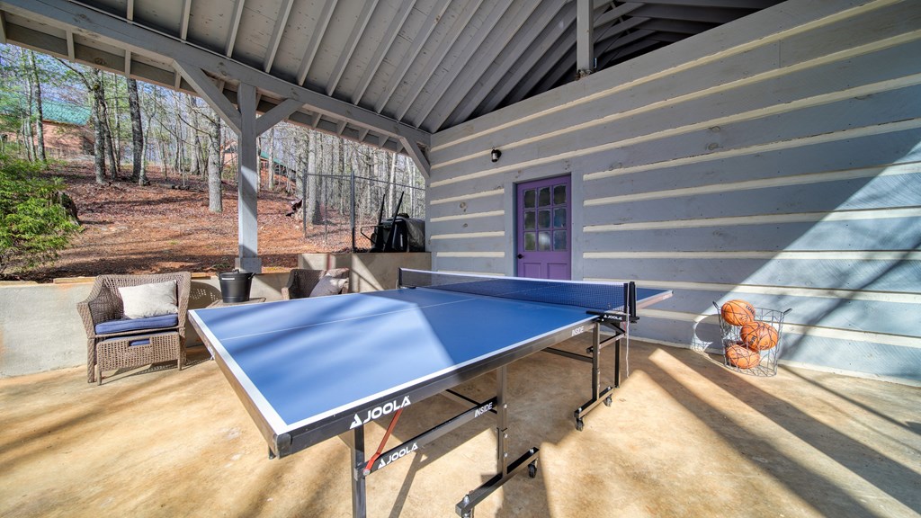 492 Chinkapin Drive Blue Ridge, GA 30513 - Photo 34 of 45 a view of a patio with table and chairs with wooden floor and fence