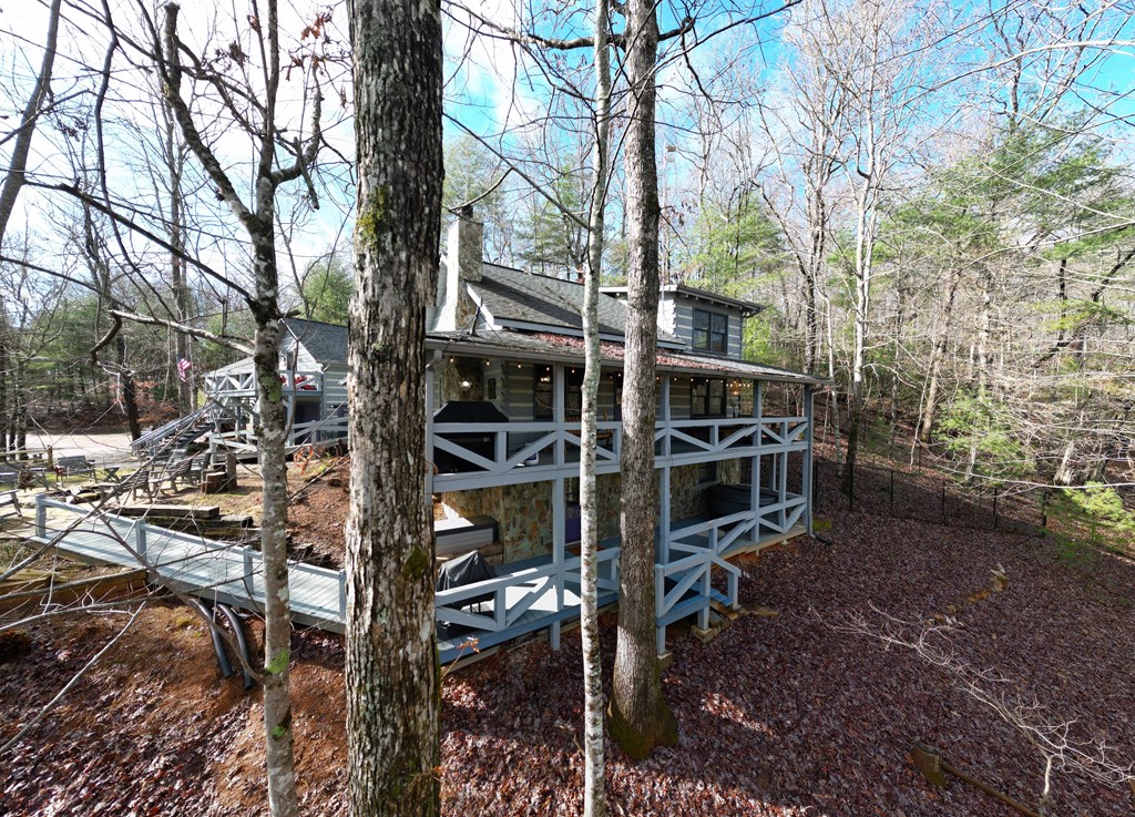 492 Chinkapin Drive Blue Ridge, GA 30513 - Photo 4 of 45 a backyard of a house with barbeque oven and large trees