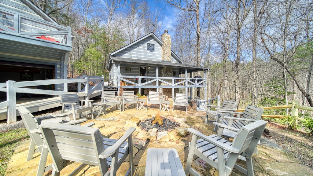 492 Chinkapin Drive Blue Ridge, GA 30513 - Photo 41 of 45 a view of a patio with table and chairs with wooden floor and fence