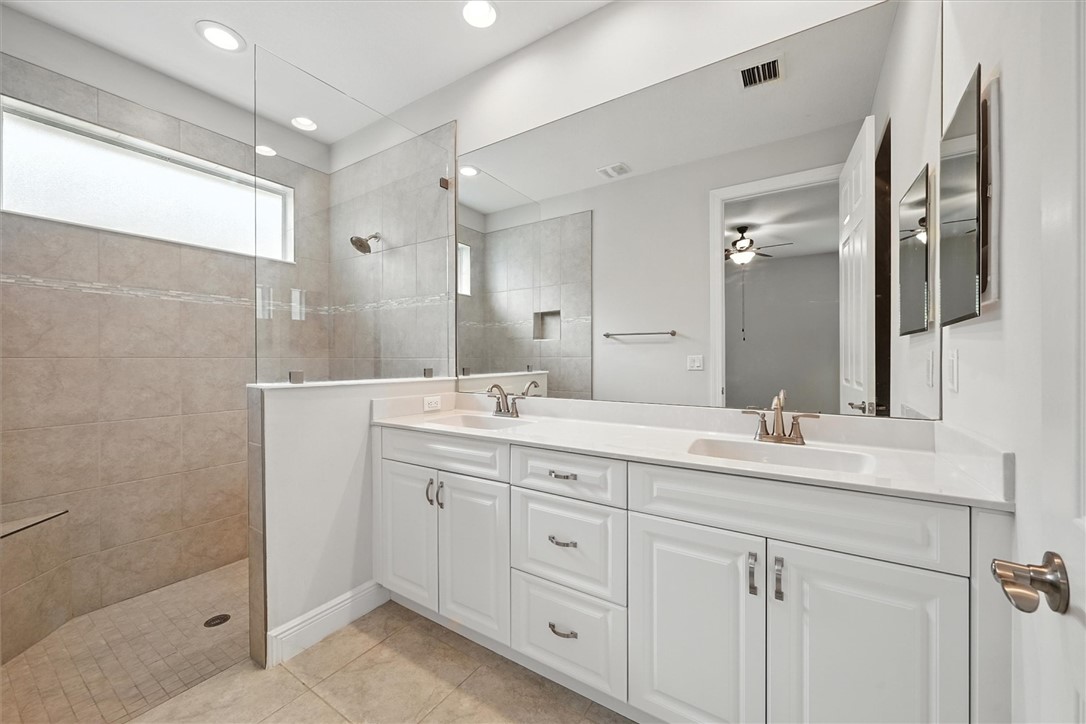 6096 Bella Rosa Lane Vero Beach, FL 32966 - Photo 12 of 33 a bathroom with a double vanity sink and mirror