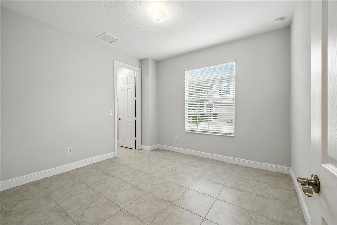 6096 Bella Rosa Lane Vero Beach, FL 32966 - Photo 18 of 33 an empty room with windows