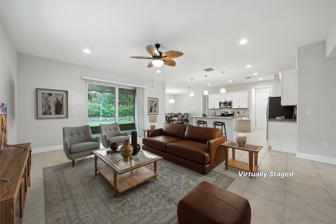 6096 Bella Rosa Lane Vero Beach, FL 32966 - Photo 2 of 33 a living room with furniture kitchen view and a large window