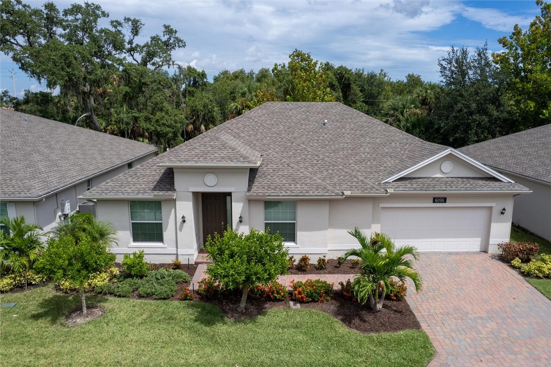 6096 Bella Rosa Lane Vero Beach, FL 32966 - Photo 26 of 33 a aerial view of a house with a yard and potted plants