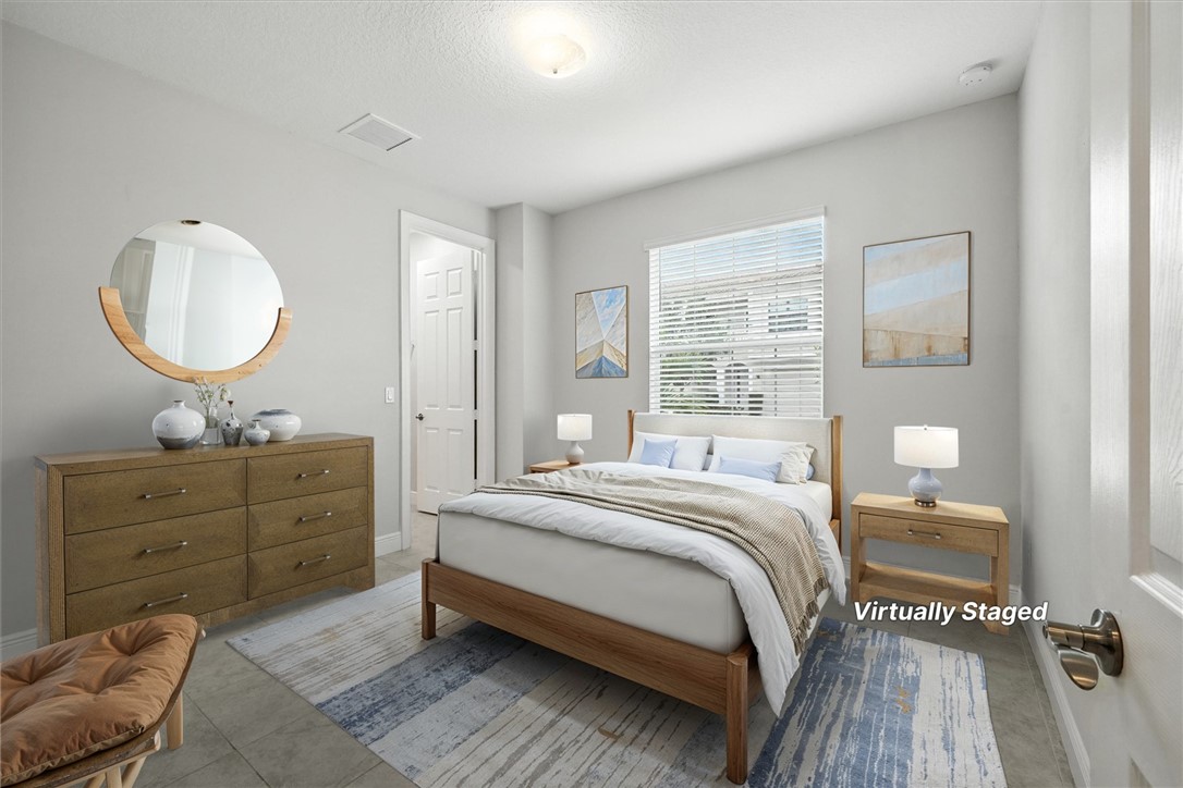 6096 Bella Rosa Lane Vero Beach, FL 32966 - Photo 10 of 33 a spacious bedroom with a bed and a dresser