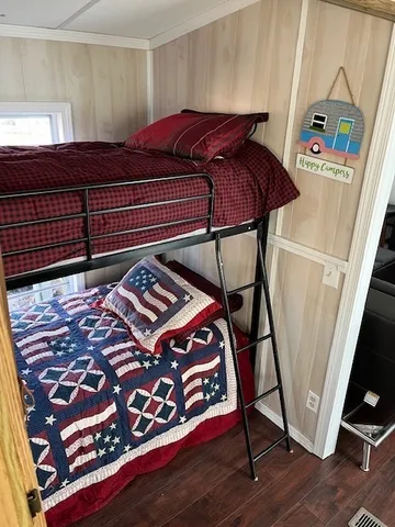 a bed sitting in a bedroom next to a window