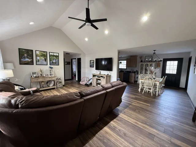 a living room with furniture and wooden floor