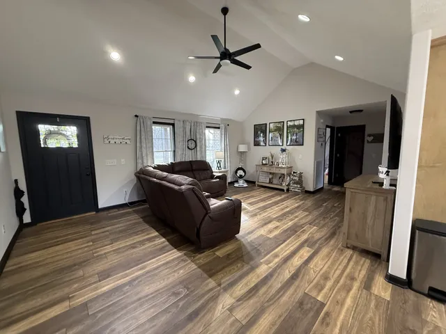 a living room with furniture and a wooden floor