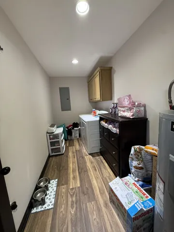 a bedroom with a bed and a flat tv screen on the dresser