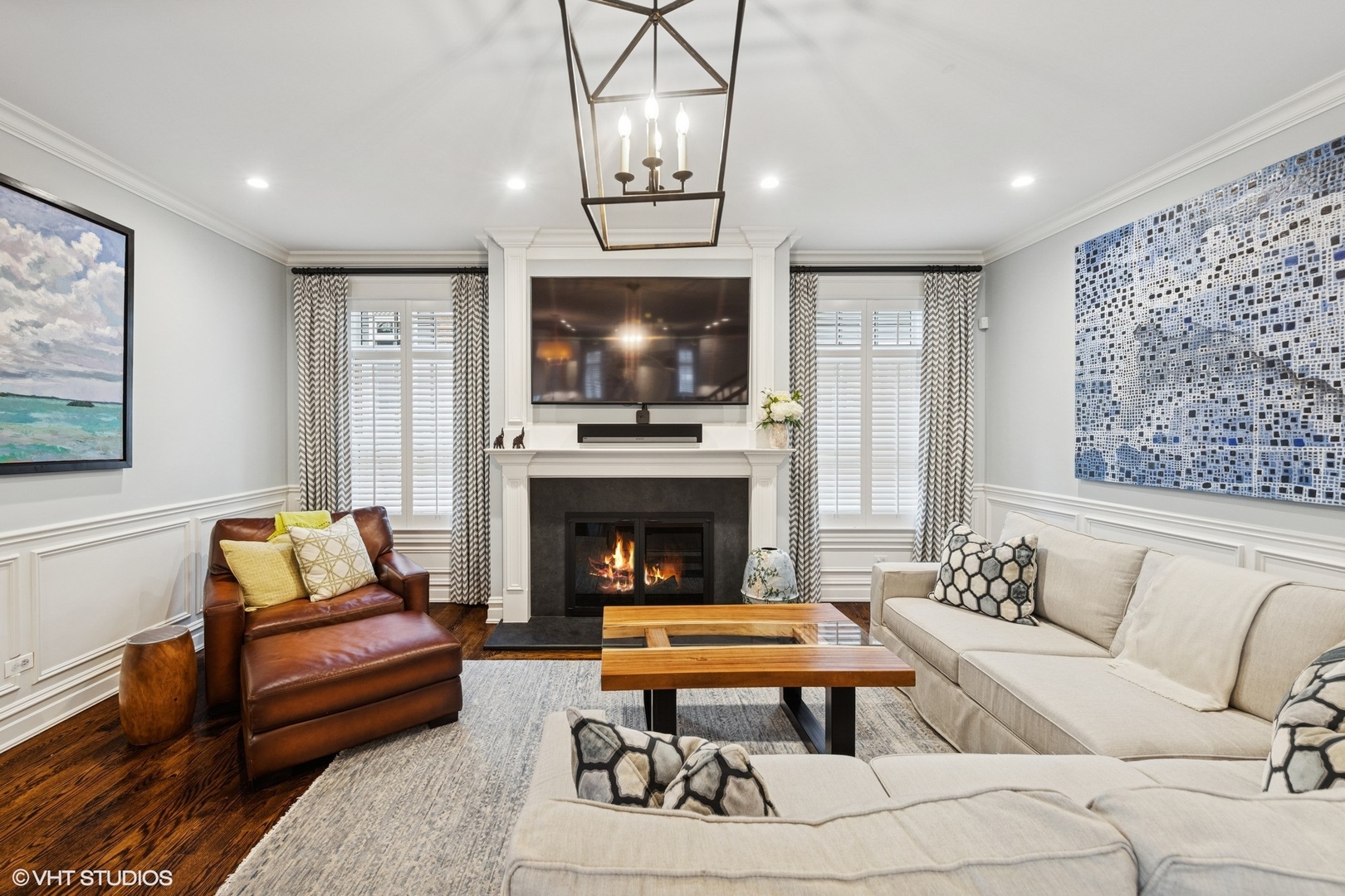 535 Walker Road Hinsdale, IL 60521 - Photo 3 of 29 a living room with furniture a flat screen tv and a fireplace