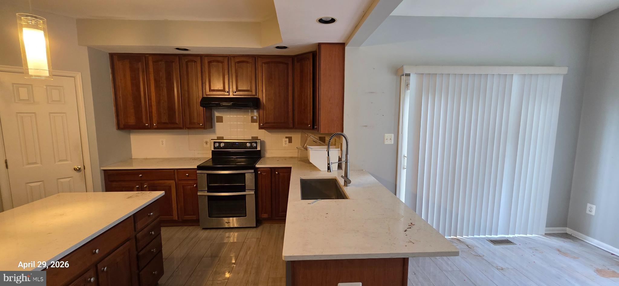 106 Sunlight Drive Frederick, MD 21702 - Photo 15 of 38 a kitchen with kitchen island granite countertop wooden cabinets and a stove