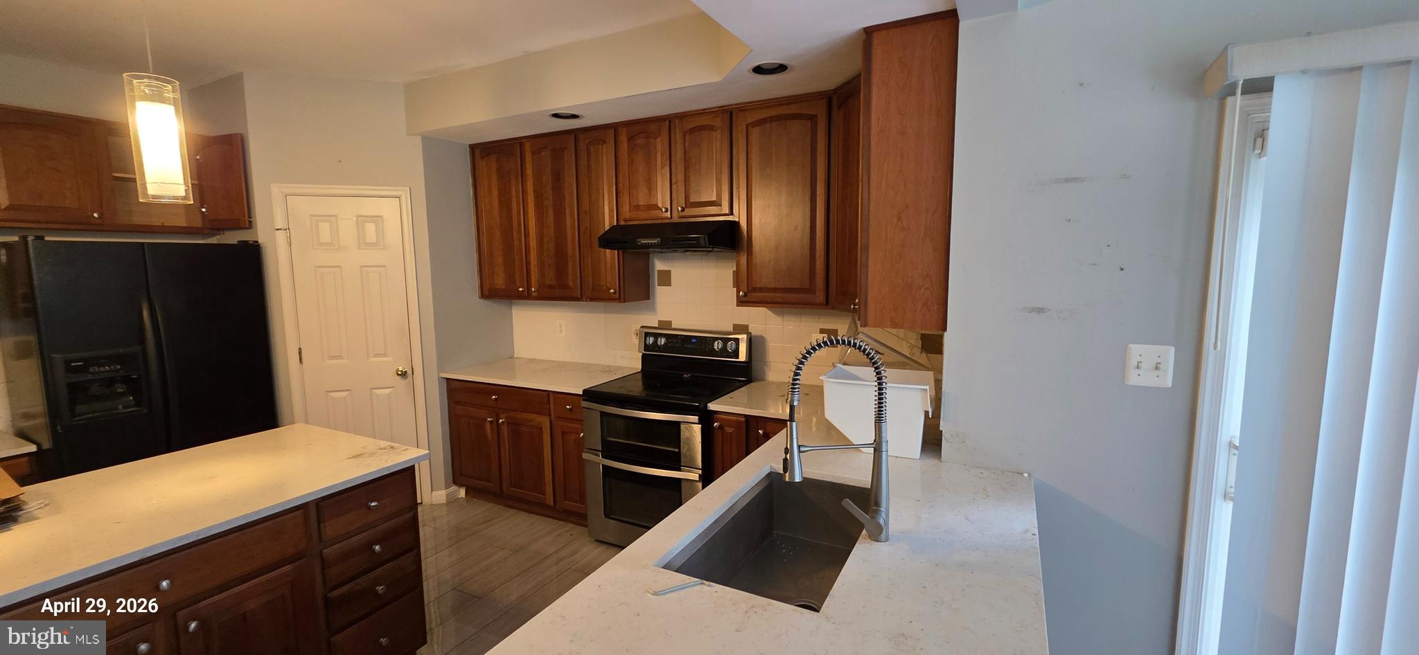 106 Sunlight Drive Frederick, MD 21702 - Photo 16 of 38 a kitchen with a refrigerator and a stove top oven