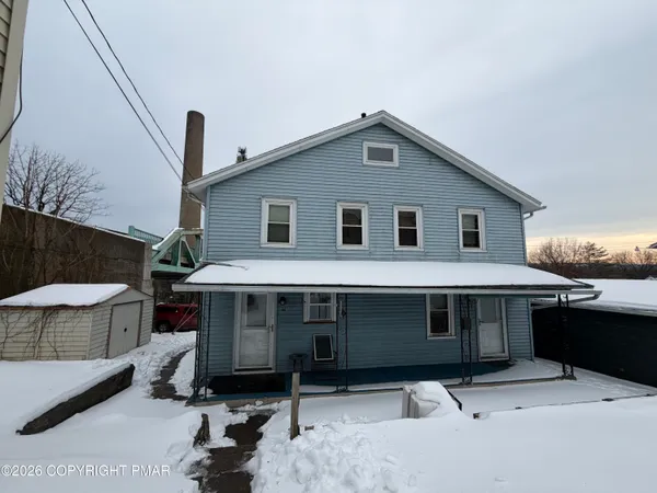 a front view of a house with garage