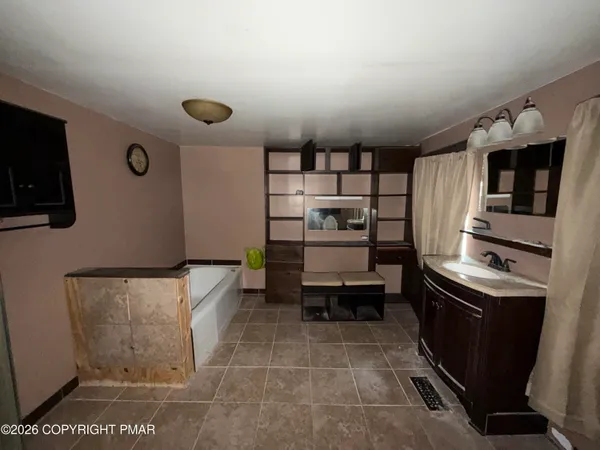 a bathroom with a tub and a shower