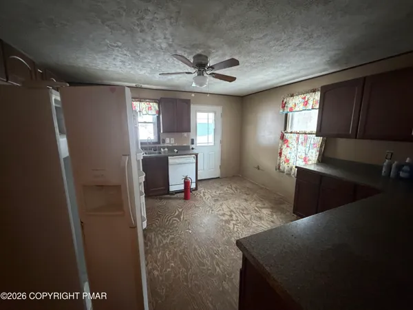 a kitchen with stainless steel appliances granite countertop a sink a stove and a refrigerator