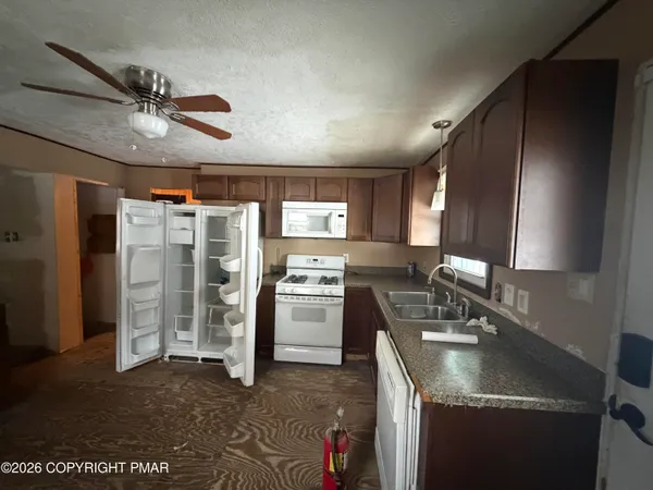 a kitchen with a sink appliances and cabinets
