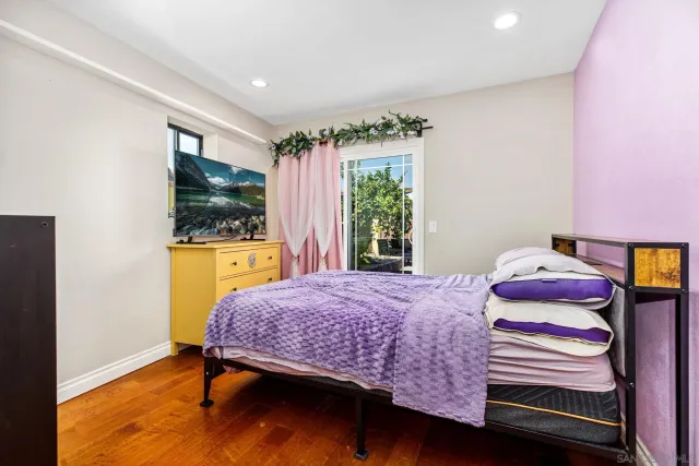 a bedroom with a bed and a flat screen tv