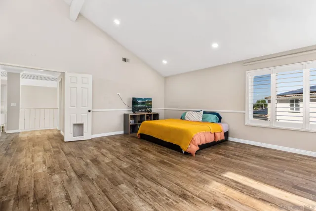 a spacious bedroom with a bed and window