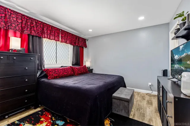 a bedroom with a bed and a tv