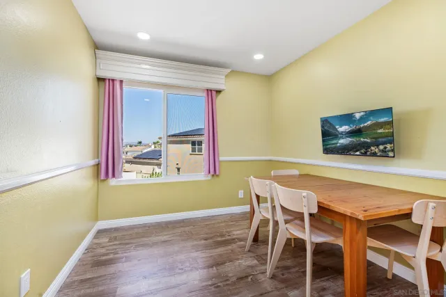 a view of a dining room with furniture and a window