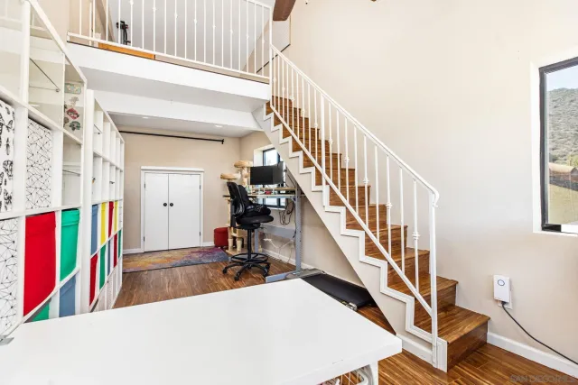 a view of entryway and hall with wooden floor