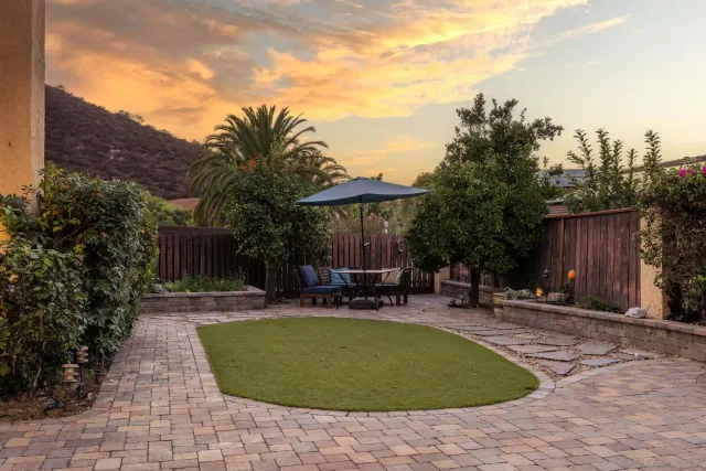 a view of a swimming pool with a patio and a garden
