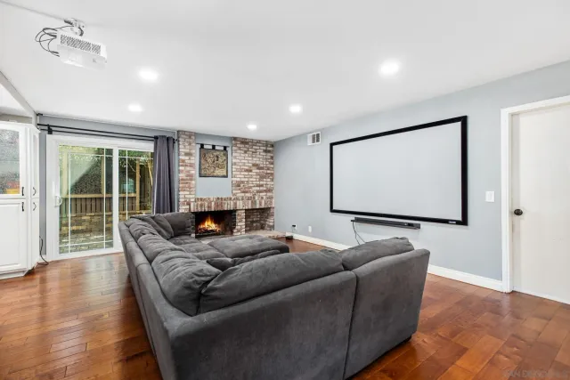 a living room with furniture projector and screen