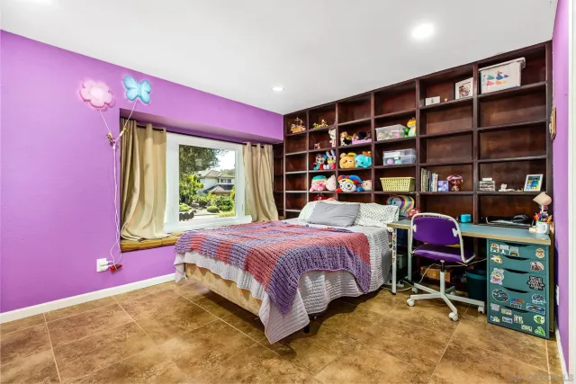 a bedroom with a bed and a bookshelf