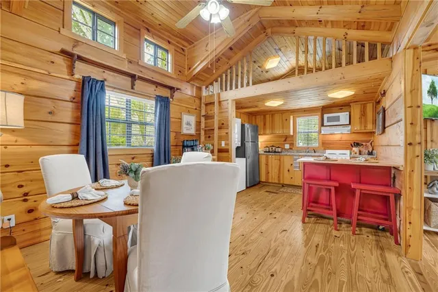 a big room with wooden roof and windows