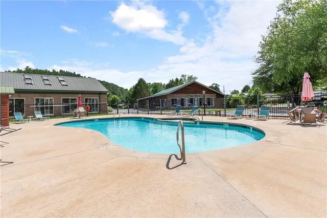 a view of swimming pool with outdoor seating