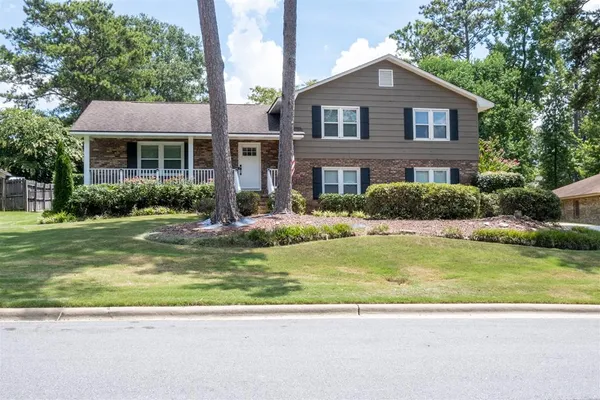 a front view of a house with a yard