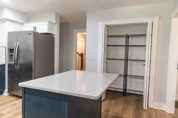 a kitchen with stainless steel appliances a refrigerator and microwave