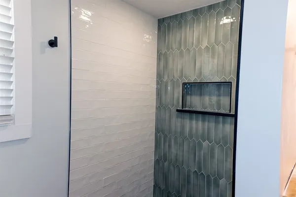 a bathroom with a shower and a sink