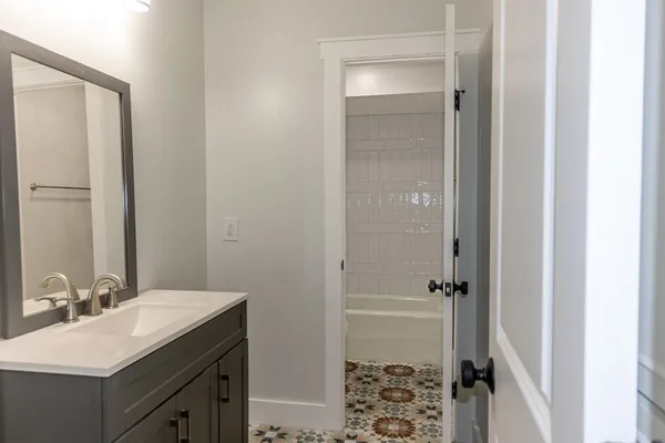 a bathroom with a sink and a mirror
