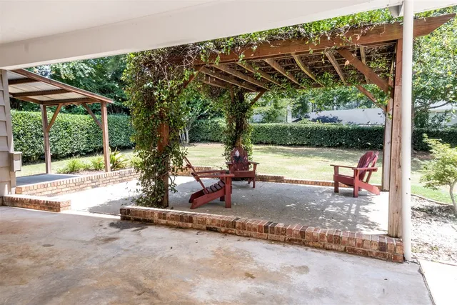 a view of a patio with a table chairs and a tub