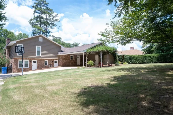a front view of a house with a garden