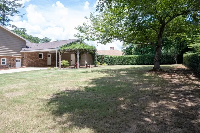a backyard of a house with yard and trees
