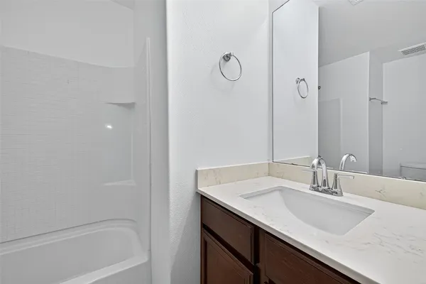 a white bath tub sitting next to a white toilet