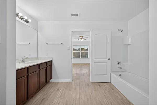 a bathroom with a granite countertop sink a toilet and a mirror