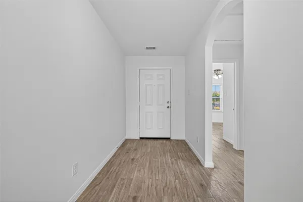 a view of a room with wooden floor