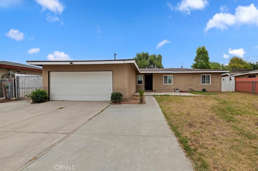 5599 Montgomery Street Riverside, CA 92503 - Photo 1 of 1 a front view of a house with a yard and garage