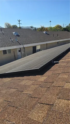 a view of terrace with lawn chairs and large tree